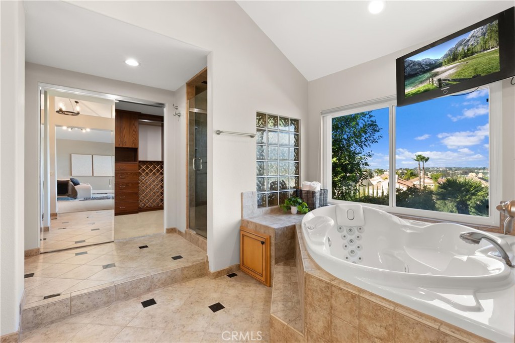 8 Rimani Drive Mission Viejo, CA 92692 - Photo 26 of 56 a bathroom with a tub a sink and a large mirror