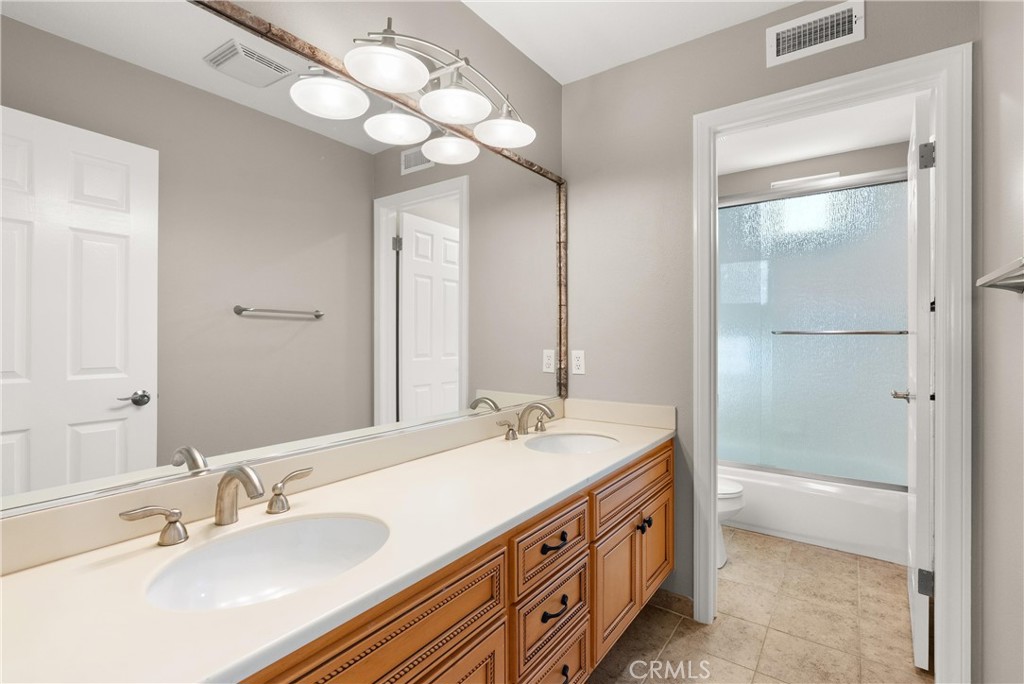 8 Rimani Drive Mission Viejo, CA 92692 - Photo 30 of 56 a bathroom with a double vanity sink and a mirror