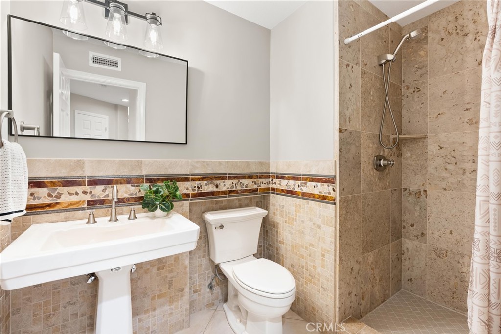 8 Rimani Drive Mission Viejo, CA 92692 - Photo 39 of 56 a bathroom with a toilet sink shower and mirror