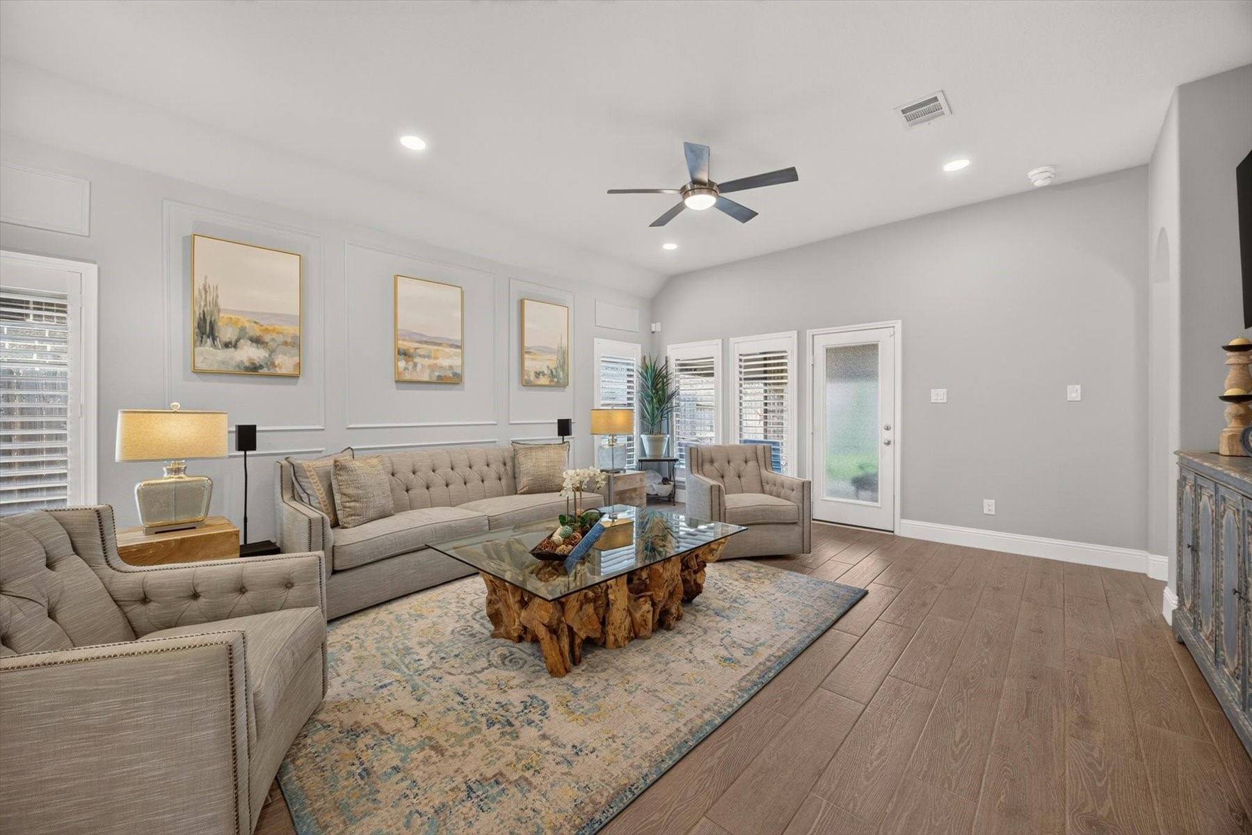 23026 Needle Grass Road Katy, TX 77493 - Photo 12 of 33 Light-filled family room with views of the backyard and covered patio. Elegant wall moldings and custom shutters throughout the home.