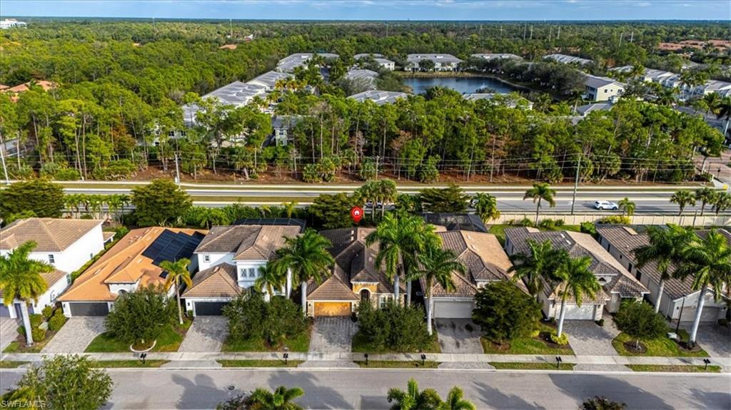1674 Serrano Circle Naples, FL 34105 - Photo 20 of 21 Aerial perspective of suburban area with a heavily wooded area