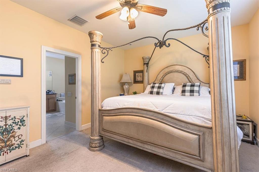 1674 Serrano Circle Naples, FL 34105 - Photo 8 of 21 Bedroom with carpet, ceiling fan, ensuite bathroom, and ornate columns
