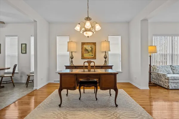 a view of a dining room with furniture wooden floor and a chandelier