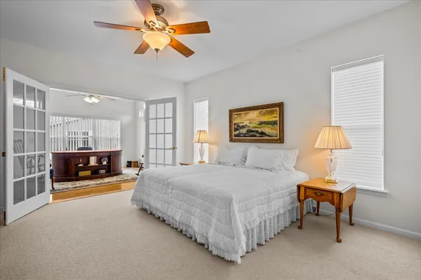 a bedroom with a bed and a chandelier