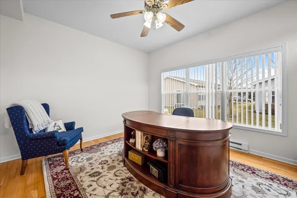 a dining room with table chairs and wooden floor