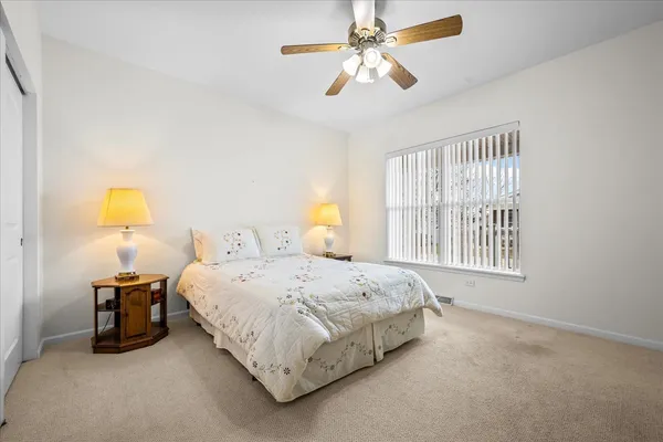 a bedroom with a bed dresser and a window