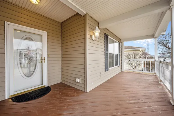 a view of a hallway with wooden floor and a fireplace