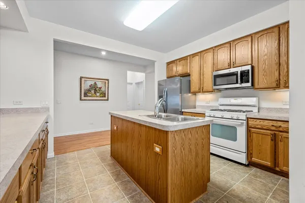 a kitchen with stainless steel appliances granite countertop a stove top oven and sink