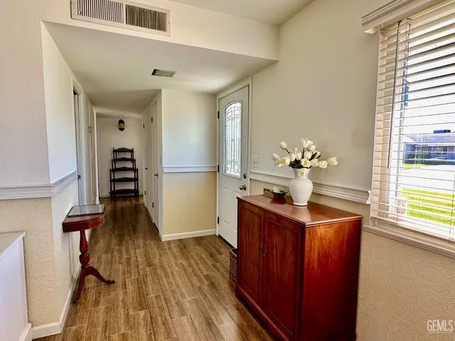 a view of a hallway with wooden floor and staircase
