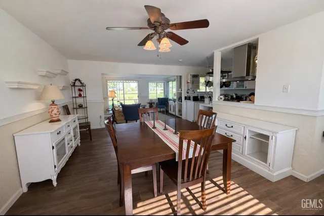 a view of kitchen with cabinets stainless steel appliances dining table and chairs