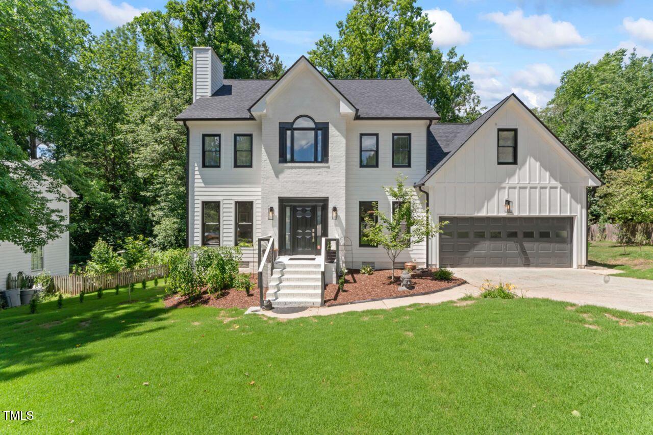 a front view of a house with a garden and yard