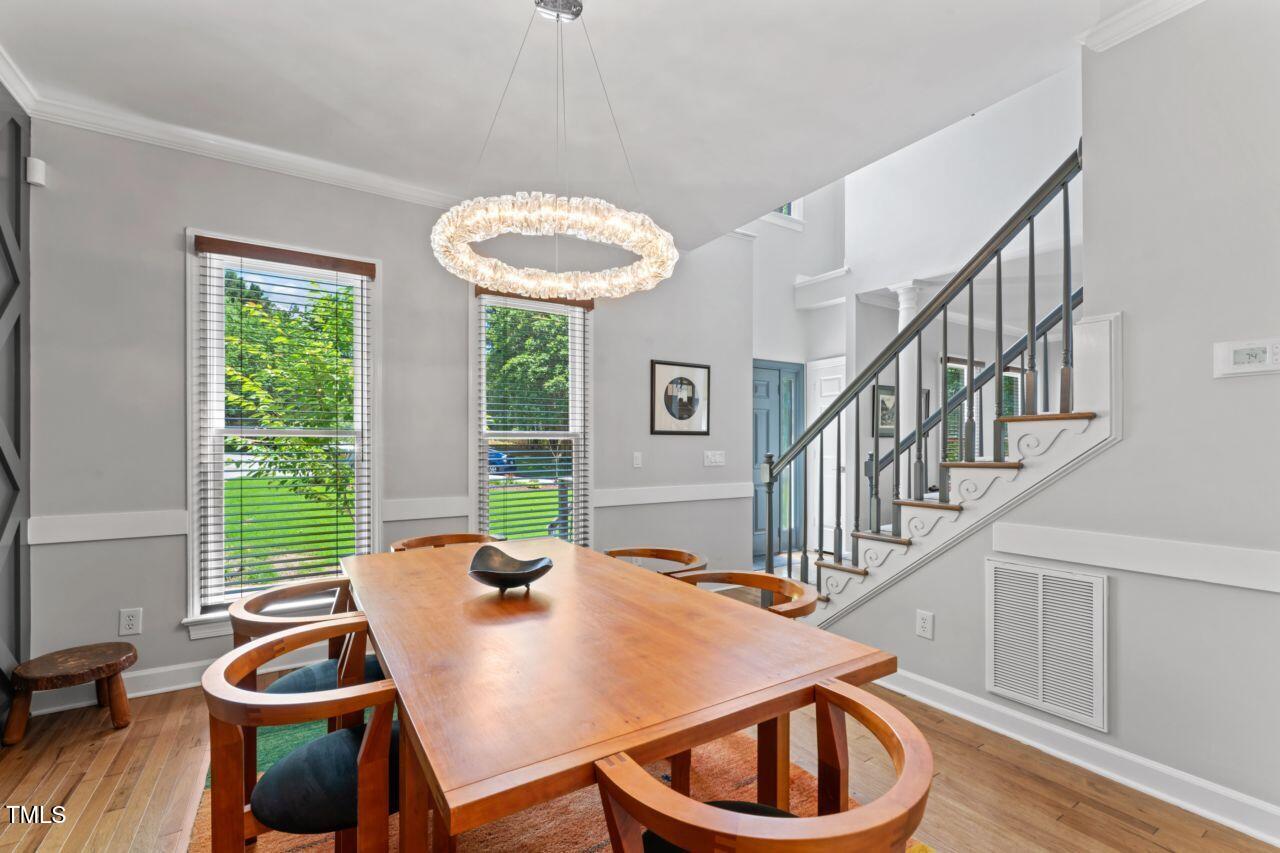 4408 Queenstown Court Raleigh, NC 27612 - Photo 11 of 49 a view of a dining room with furniture window and wooden floor