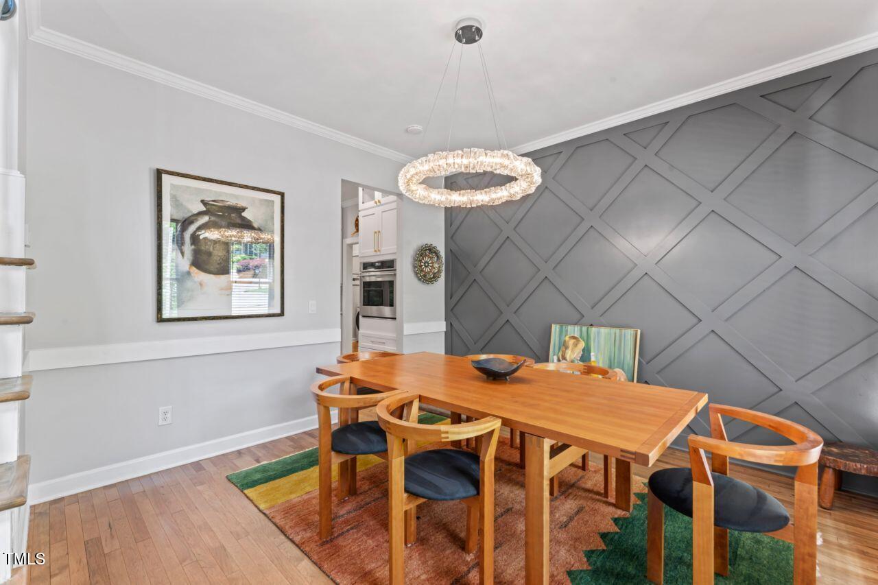 4408 Queenstown Court Raleigh, NC 27612 - Photo 12 of 49 a view of a dining room with a table and chairs