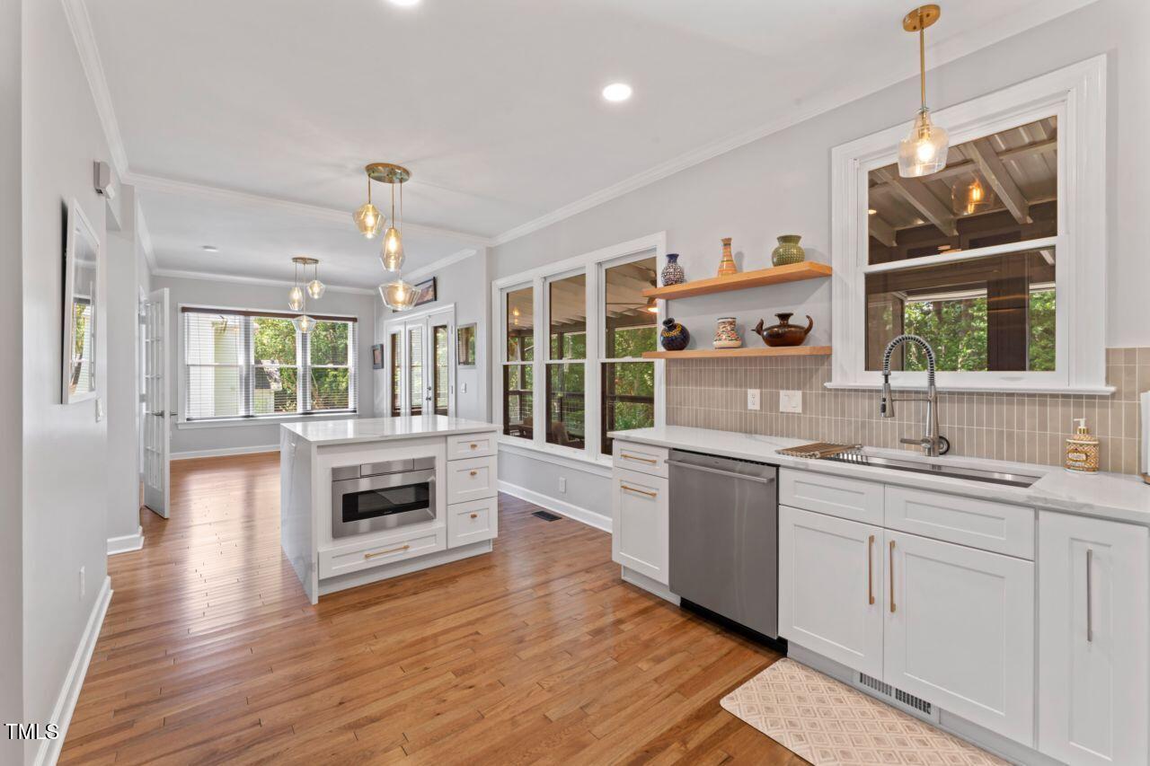 4408 Queenstown Court Raleigh, NC 27612 - Photo 16 of 49 a large kitchen with a stove a sink dishwasher and a refrigerator