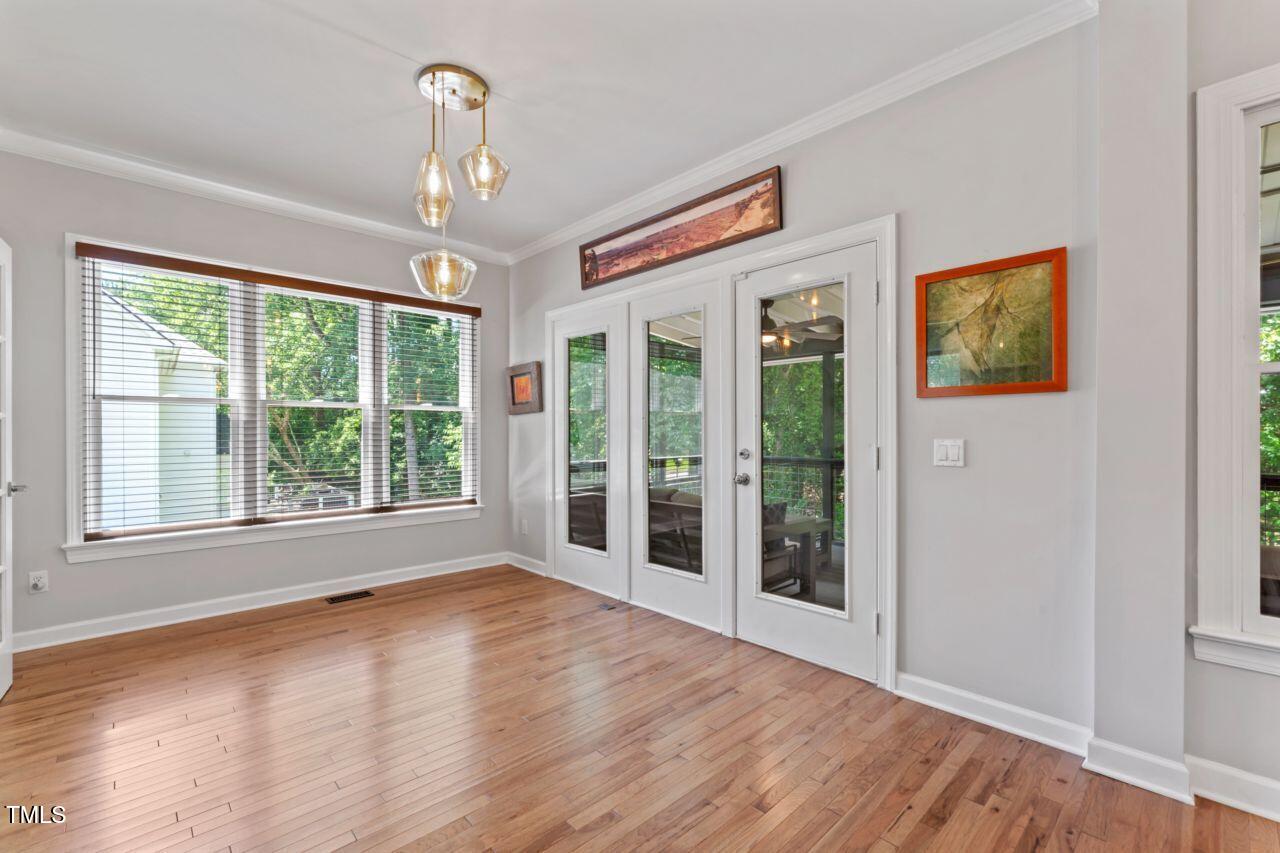 4408 Queenstown Court Raleigh, NC 27612 - Photo 19 of 49 a view of an empty room with wooden floor and a window