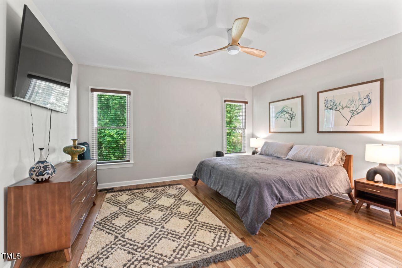 4408 Queenstown Court Raleigh, NC 27612 - Photo 24 of 49 a bedroom with a bed and wooden floor