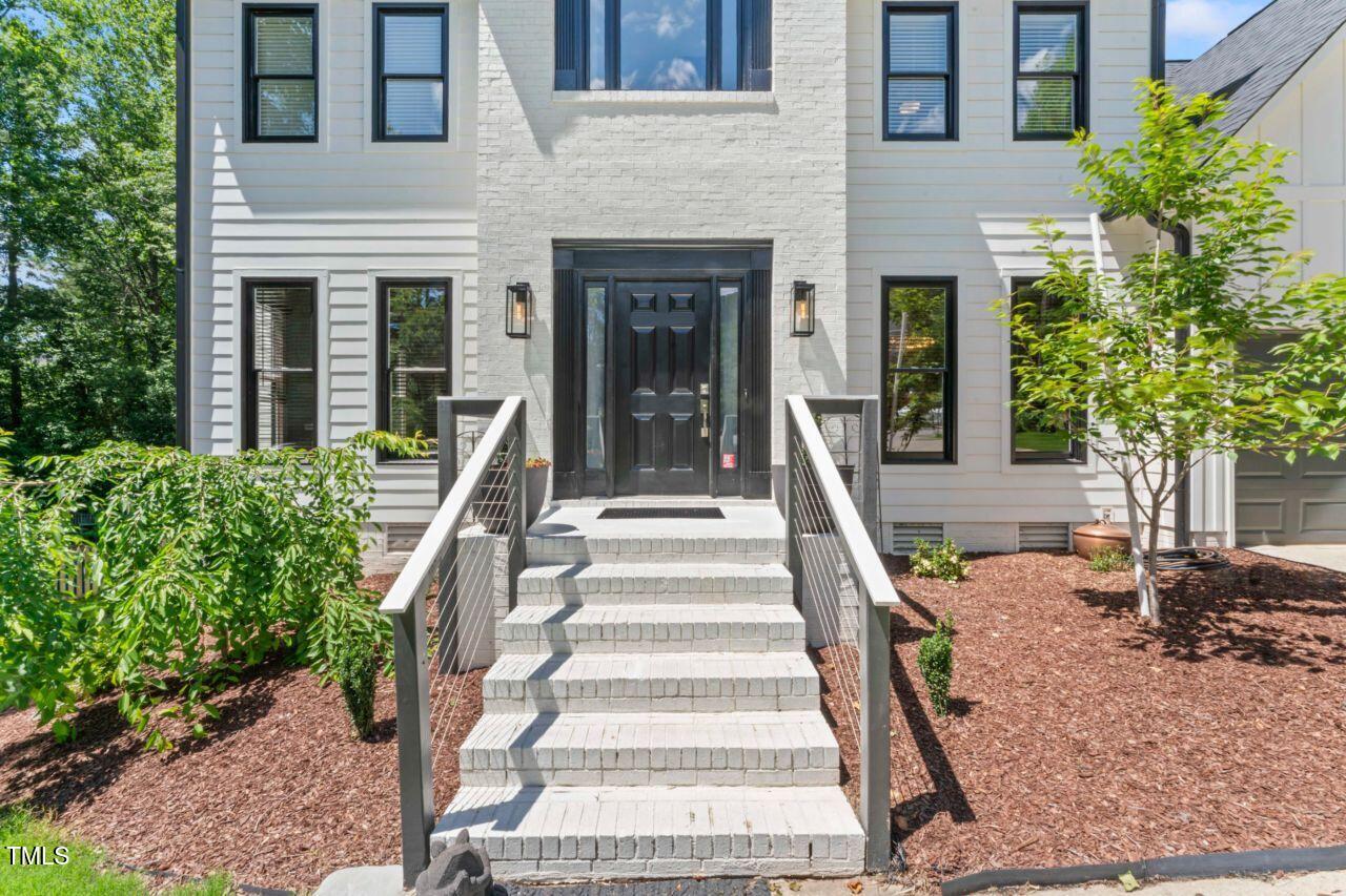 4408 Queenstown Court Raleigh, NC 27612 - Photo 3 of 49 front view of a house with a yard