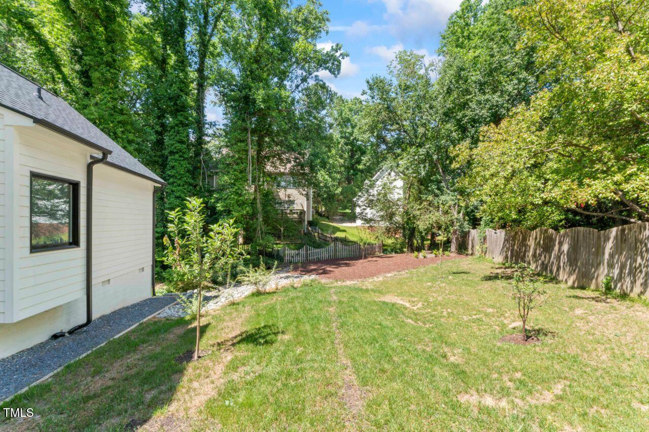 4408 Queenstown Court Raleigh, NC 27612 - Photo 45 of 49 a backyard of a house with table and chairs