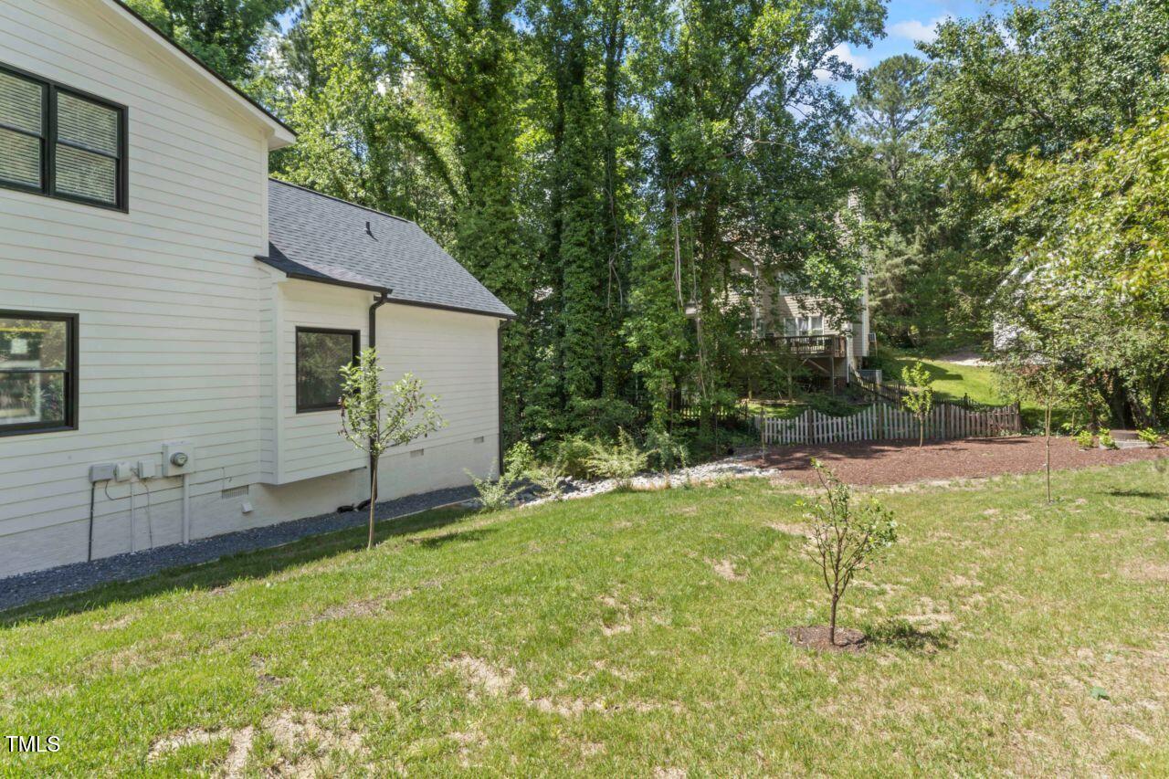 4408 Queenstown Court Raleigh, NC 27612 - Photo 46 of 49 a view of a backyard with a garden and entertaining space