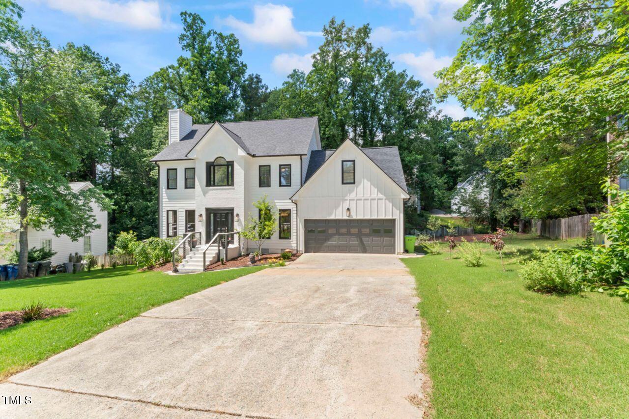 4408 Queenstown Court Raleigh, NC 27612 - Photo 4 of 49 a front view of a house with yard patio and green space