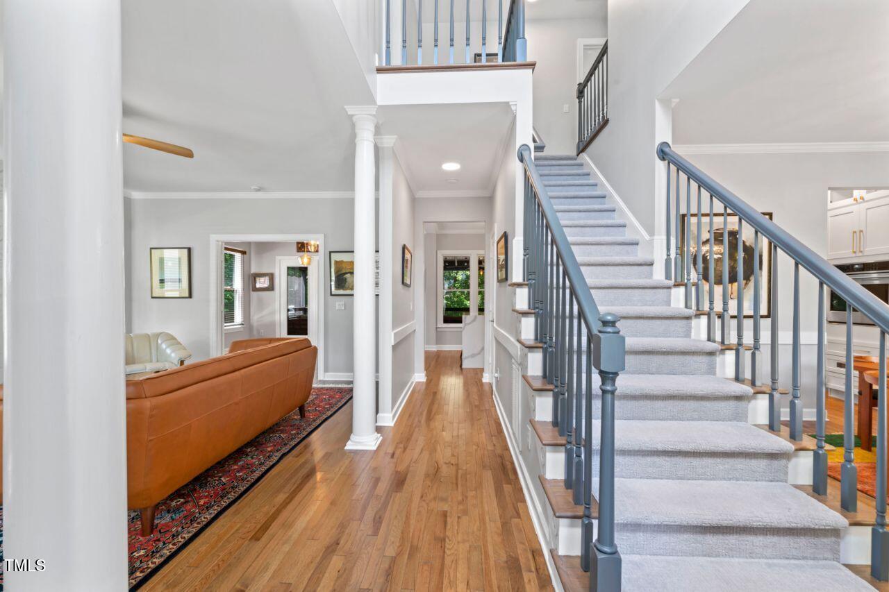 4408 Queenstown Court Raleigh, NC 27612 - Photo 5 of 49 a view of staircase with wooden floor and a rug