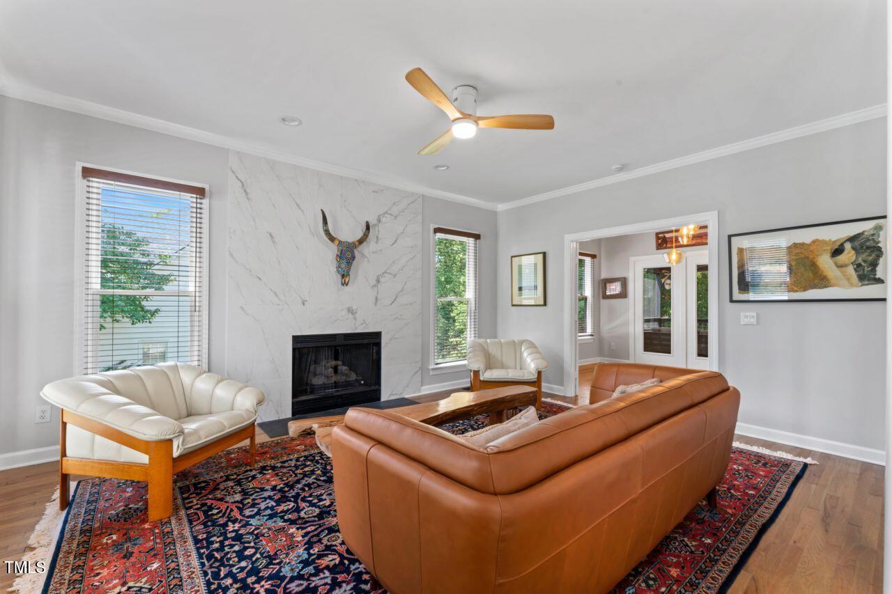4408 Queenstown Court Raleigh, NC 27612 - Photo 8 of 49 a living room with furniture and a fireplace