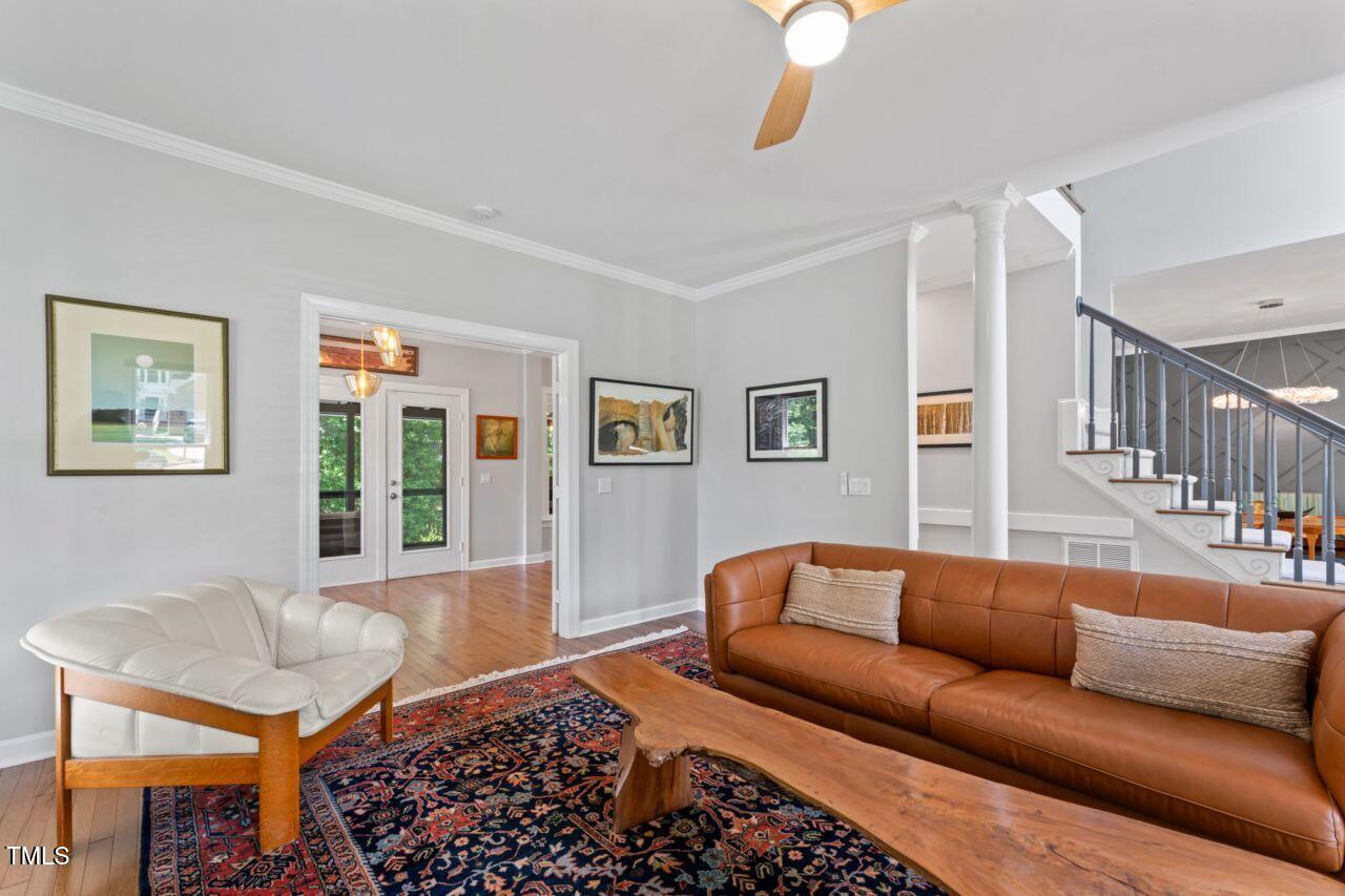 4408 Queenstown Court Raleigh, NC 27612 - Photo 9 of 49 a living room with furniture ceiling fan and a rug