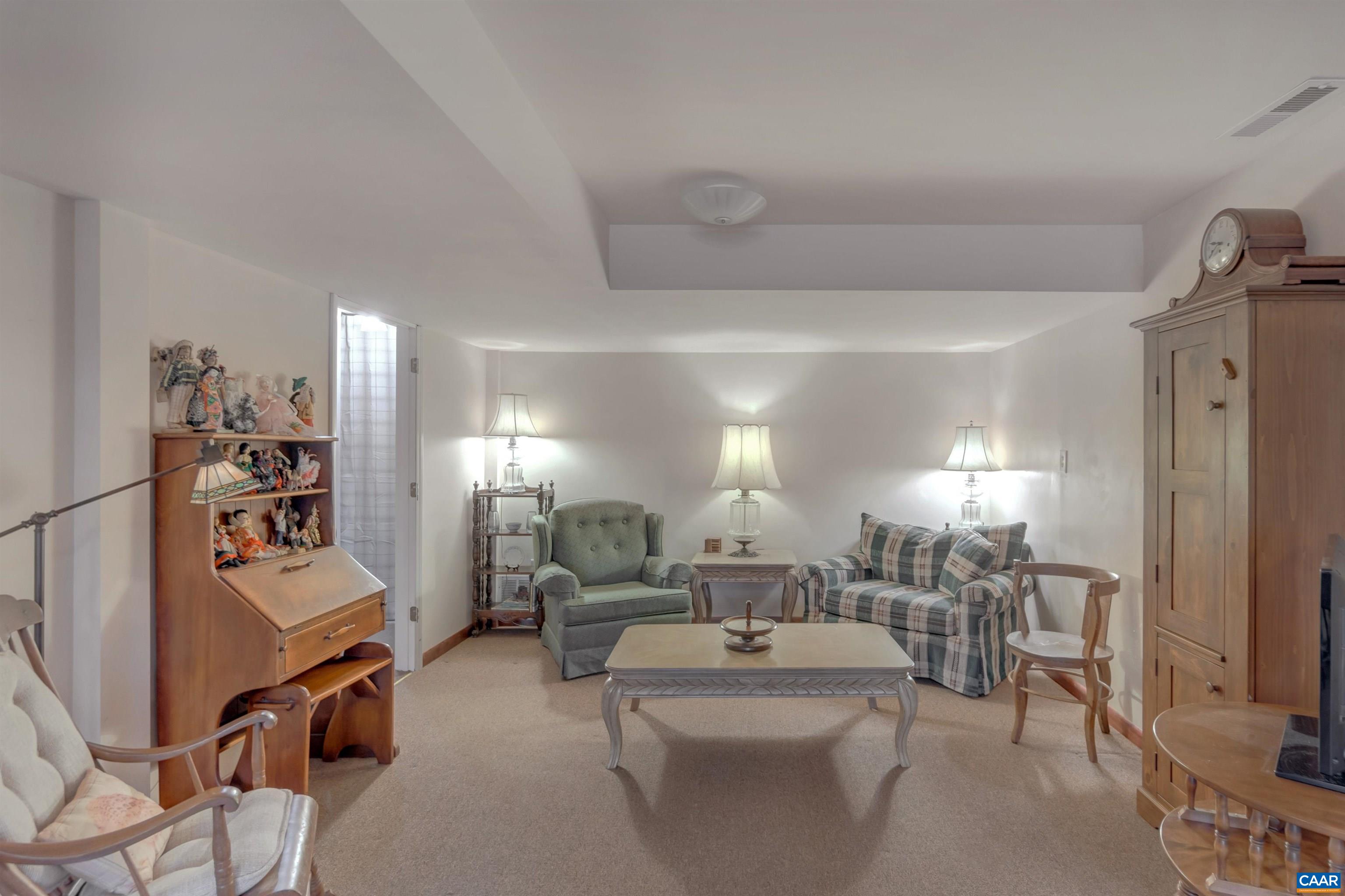 415 Rudolph Street Ruckersville, VA 22968 - Photo 26 of 38 a living room with furniture a flat screen tv and a table