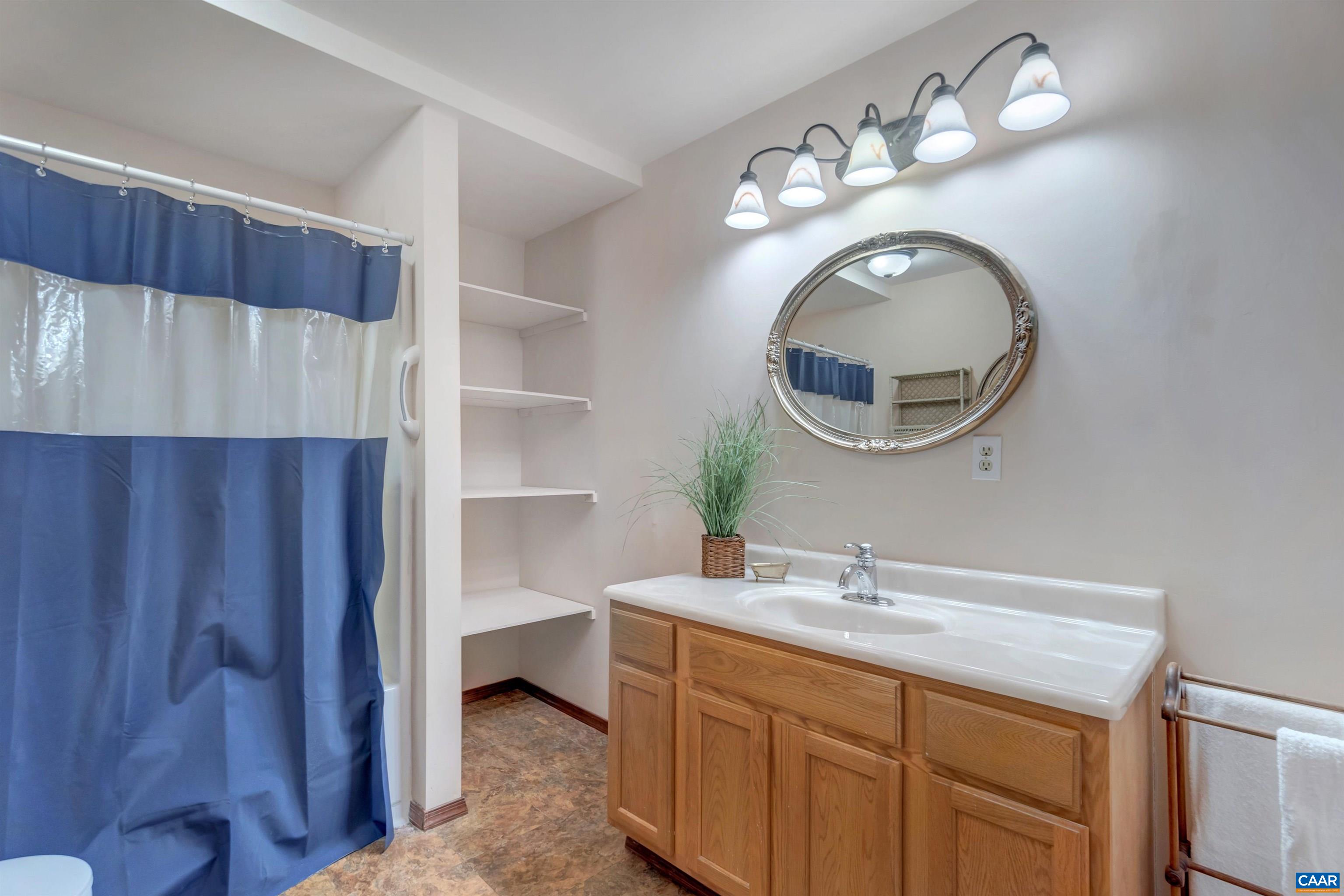 415 Rudolph Street Ruckersville, VA 22968 - Photo 29 of 38 a en suite bathroom with a sink and a mirror