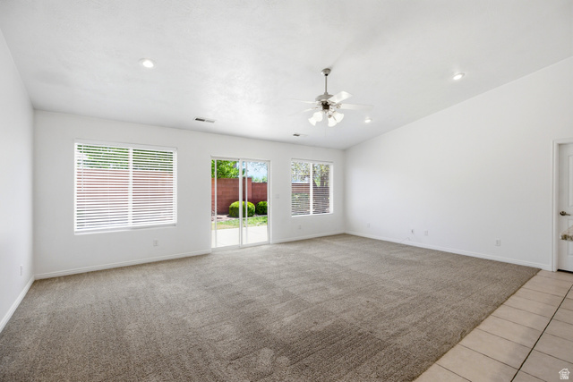 1630 East 2450th Street South, Unit 263 St. George, UT 84790 - Photo 2 of 24 Spacious living area featuring neutral carpeting, a ceiling fan, recessed lighting, and a sliding glass door to the exterior