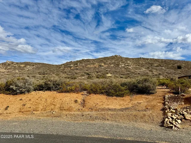 a view of mountain with sunset in background