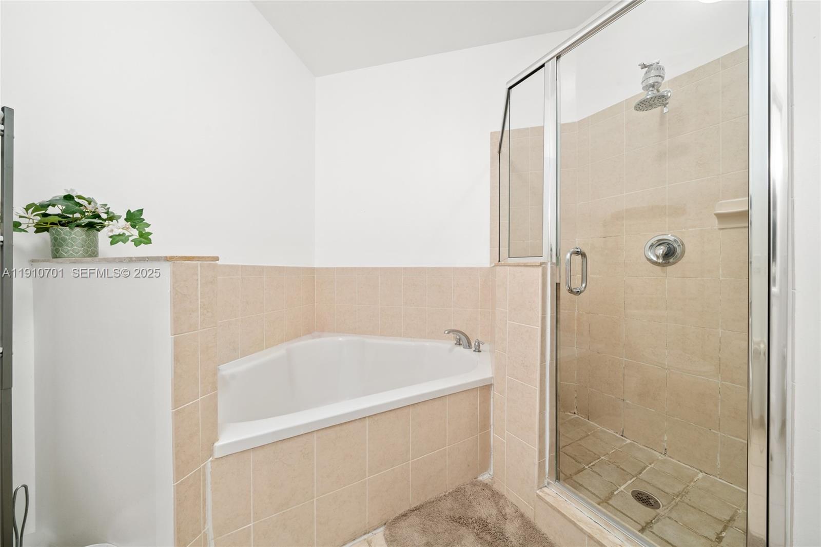 23713 Southwest 115th Avenue Homestead, FL 33032 - Photo 11 of 26 a bathroom with a bathtub and shower