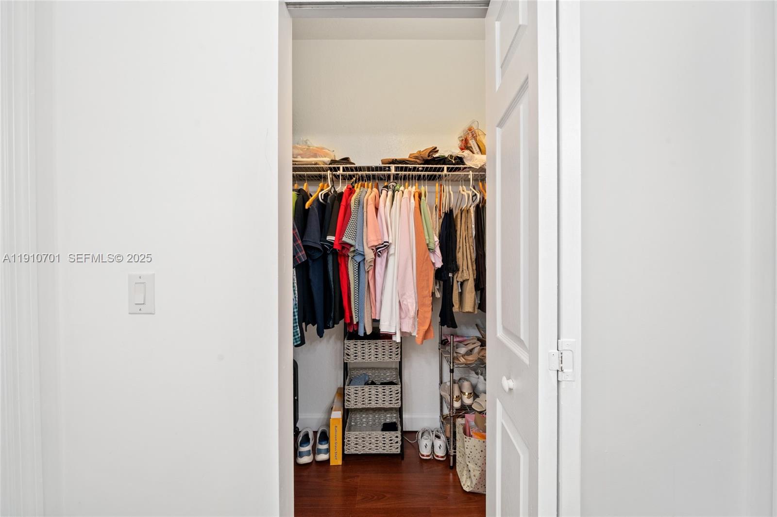 23713 Southwest 115th Avenue Homestead, FL 33032 - Photo 12 of 26 a view of walk in closet with clothes and shoes
