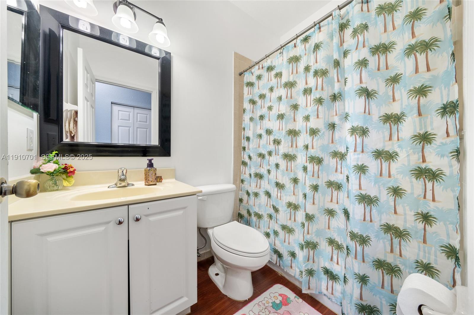 23713 Southwest 115th Avenue Homestead, FL 33032 - Photo 14 of 26 a bathroom with a sink a toilet and a mirror