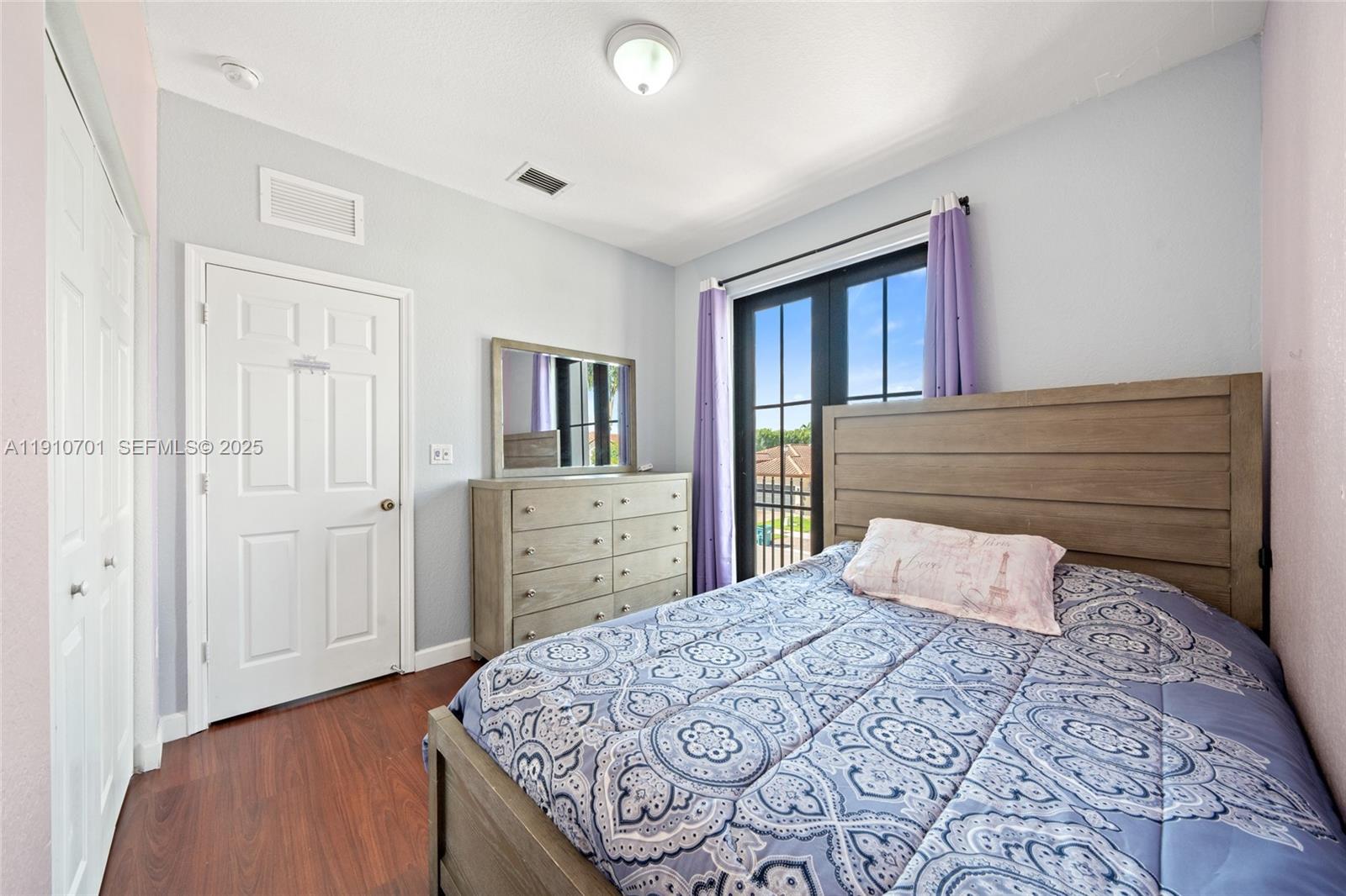 23713 Southwest 115th Avenue Homestead, FL 33032 - Photo 15 of 26 a bedroom with a bed and a dresser