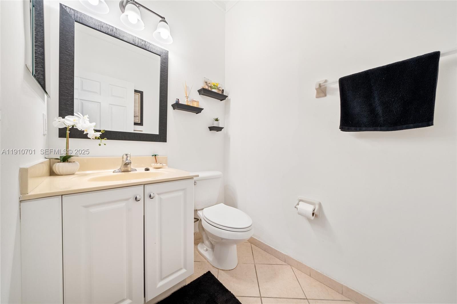 23713 Southwest 115th Avenue Homestead, FL 33032 - Photo 18 of 26 a bathroom with a toilet sink and mirror