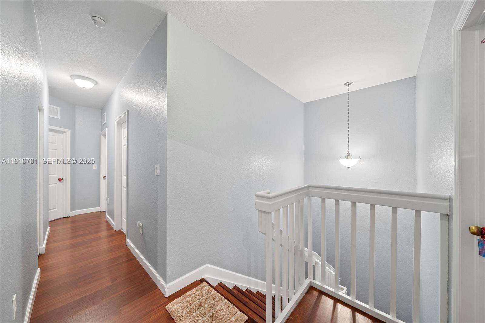 23713 Southwest 115th Avenue Homestead, FL 33032 - Photo 20 of 26 a view of a hallway with wooden floor