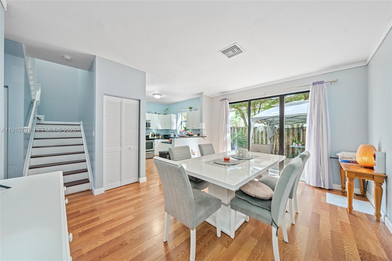 23713 Southwest 115th Avenue Homestead, FL 33032 - Photo 5 of 26 a view of a dining room with furniture window and wooden floor