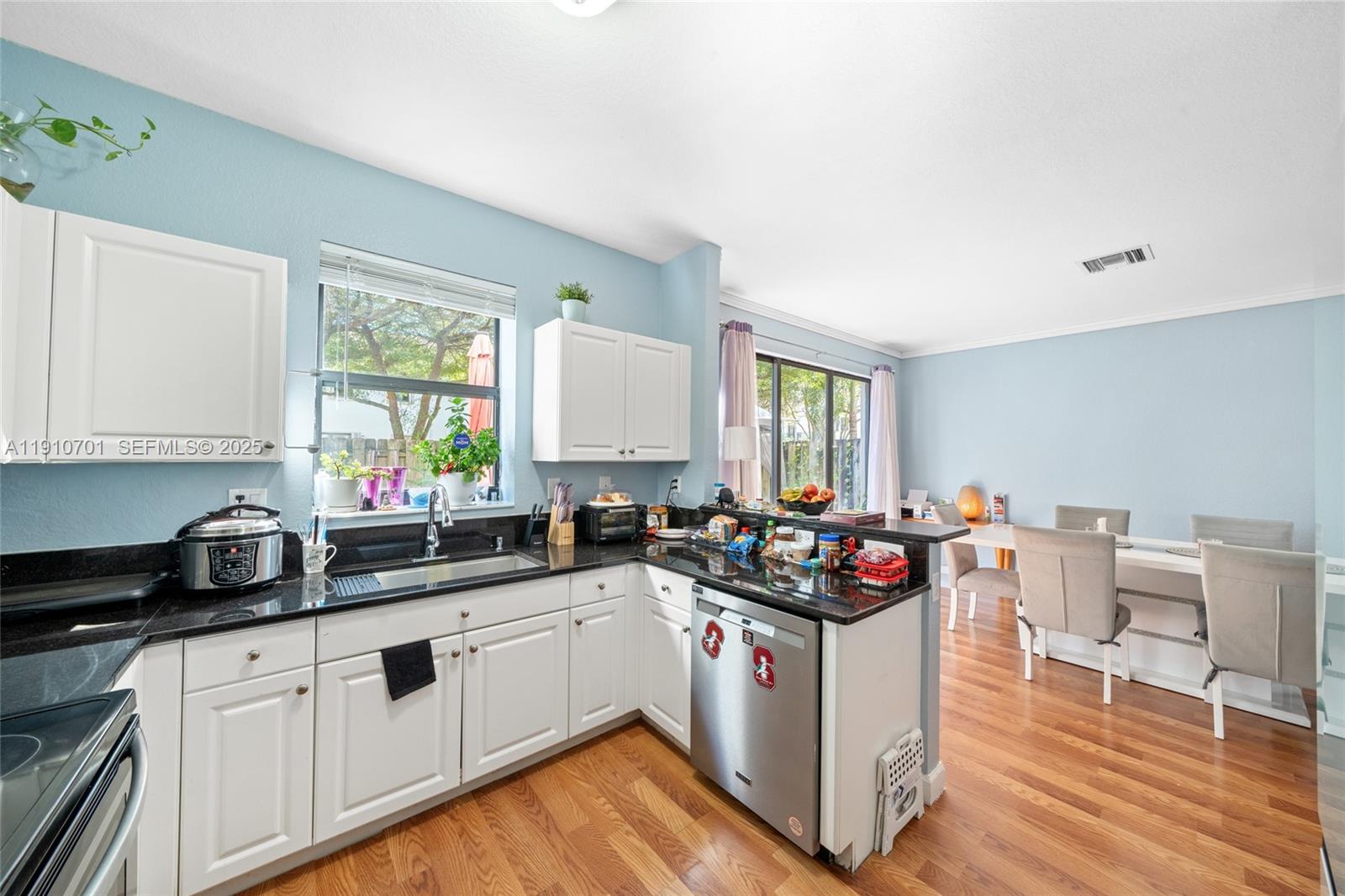 23713 Southwest 115th Avenue Homestead, FL 33032 - Photo 7 of 26 a kitchen with a sink stove and cabinets