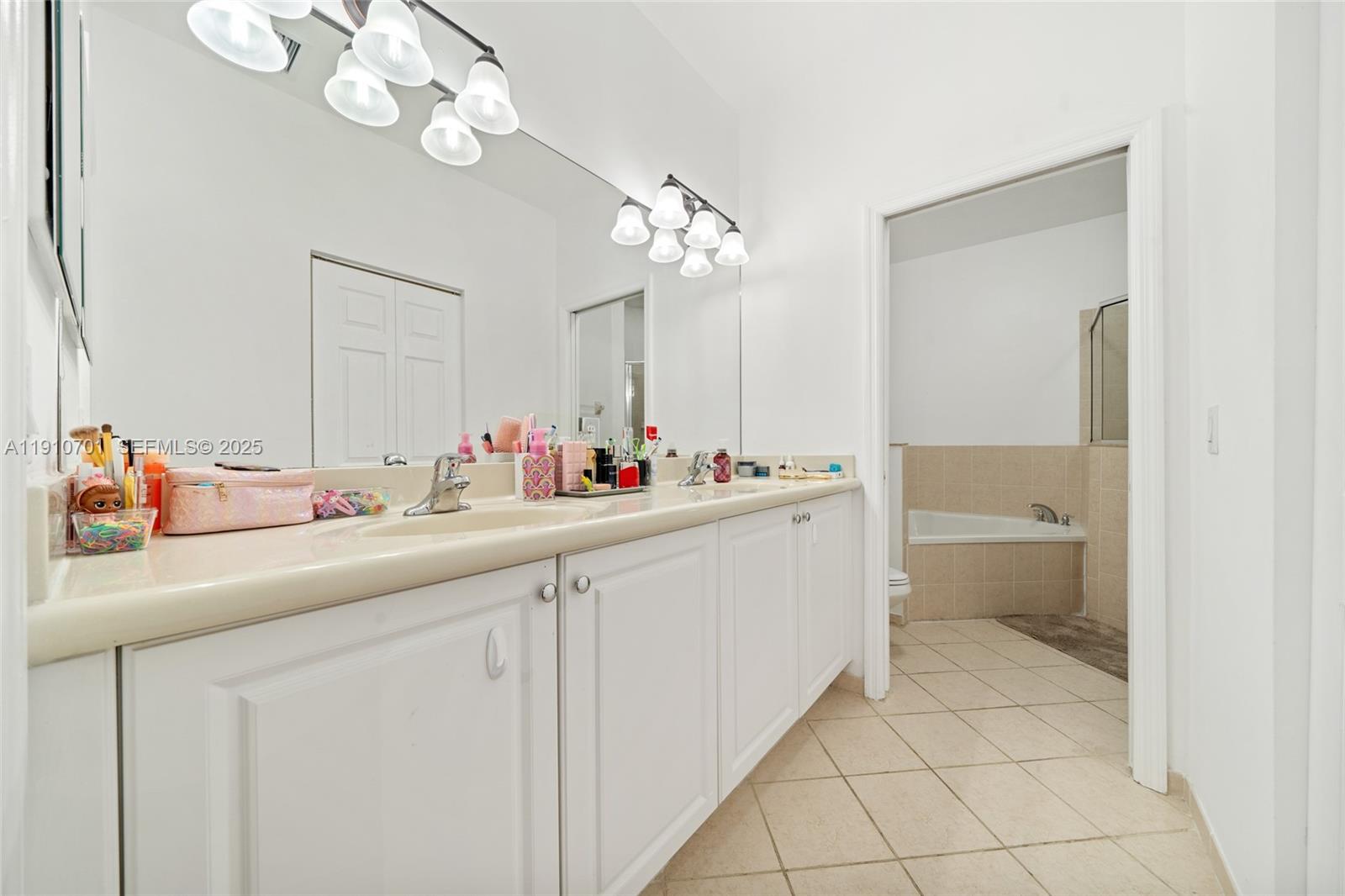 23713 Southwest 115th Avenue Homestead, FL 33032 - Photo 9 of 26 a bathroom with a sink and a mirror