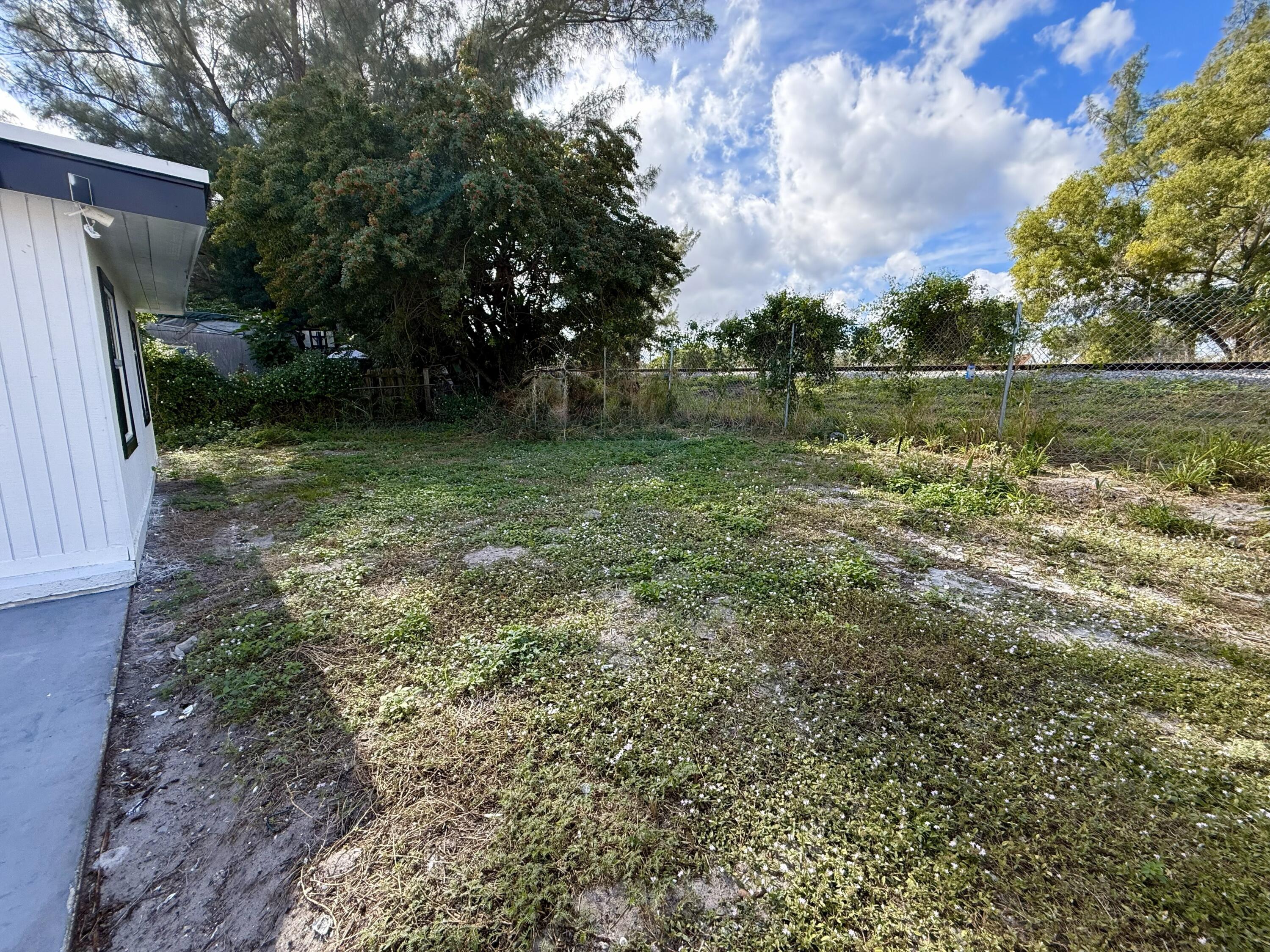 5909 Pinewood Avenue West Palm Beach, FL 33407 - Photo 11 of 11 a backyard of a house with lots of green space
