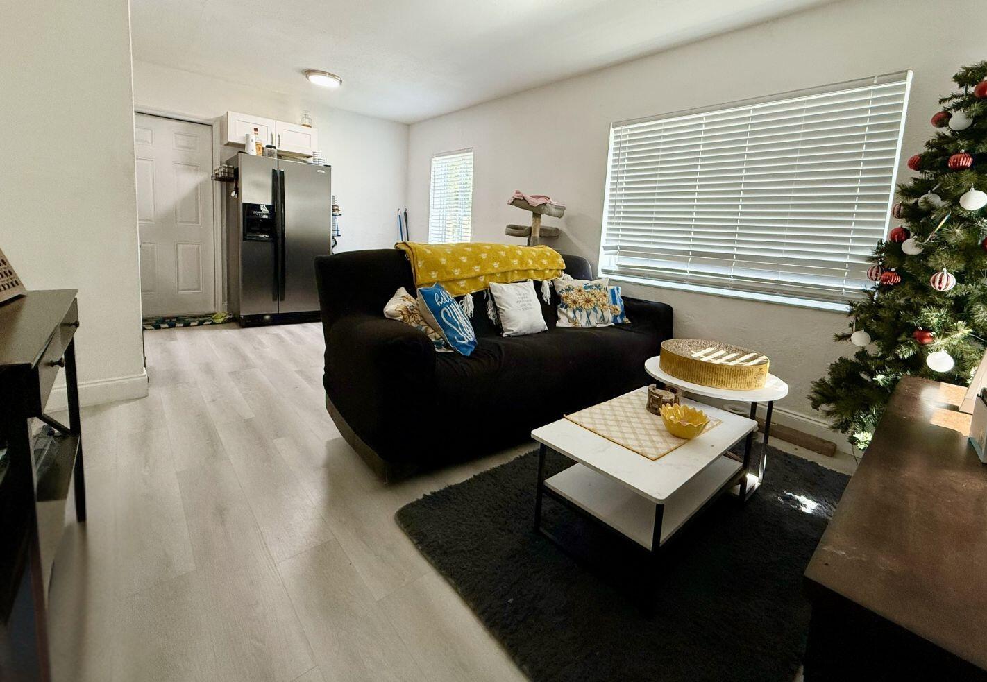 5909 Pinewood Avenue West Palm Beach, FL 33407 - Photo 5 of 11 a bedroom with furniture and a potted plant