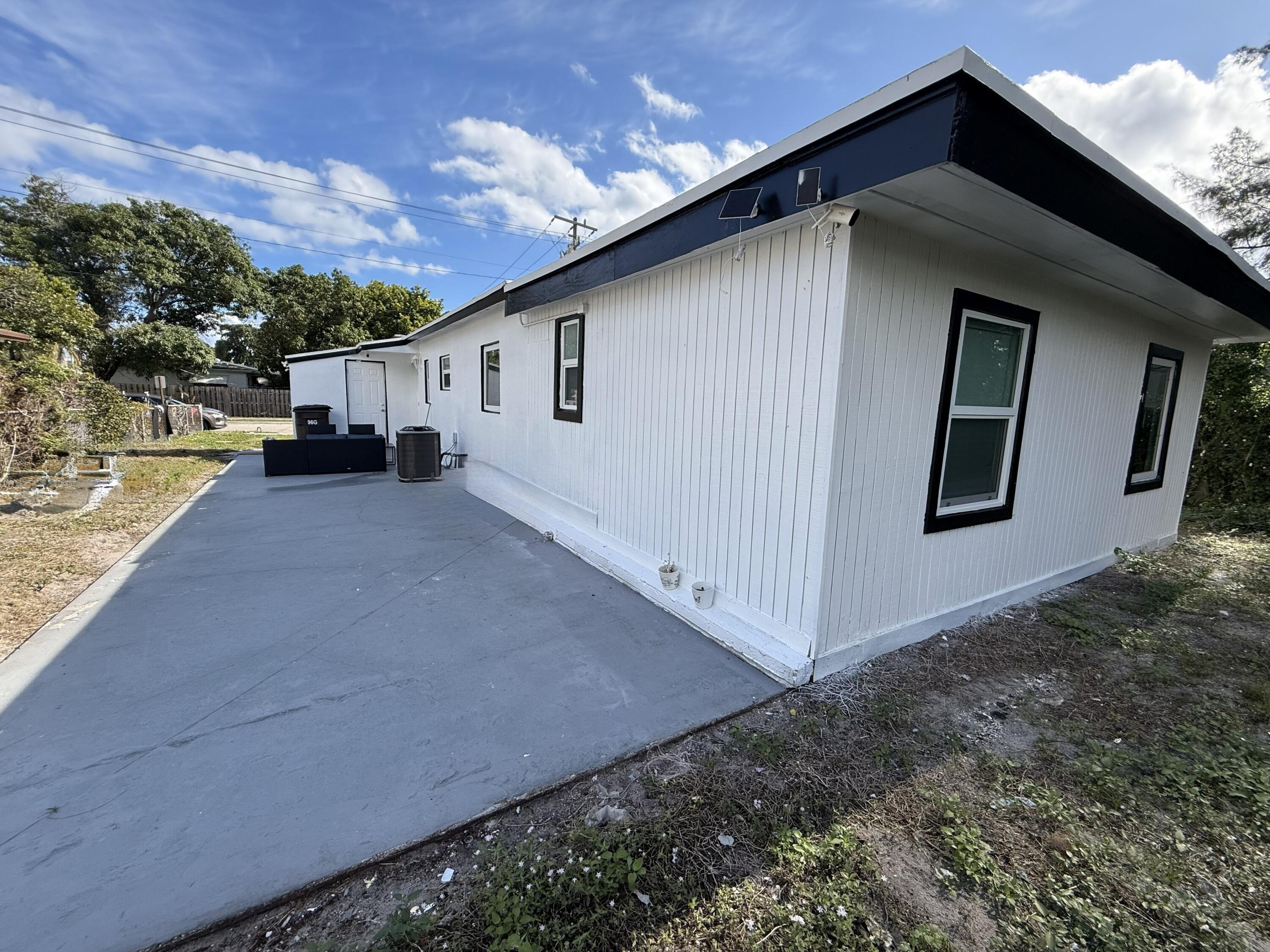 5909 Pinewood Avenue West Palm Beach, FL 33407 - Photo 8 of 11 a view of a house with a backyard
