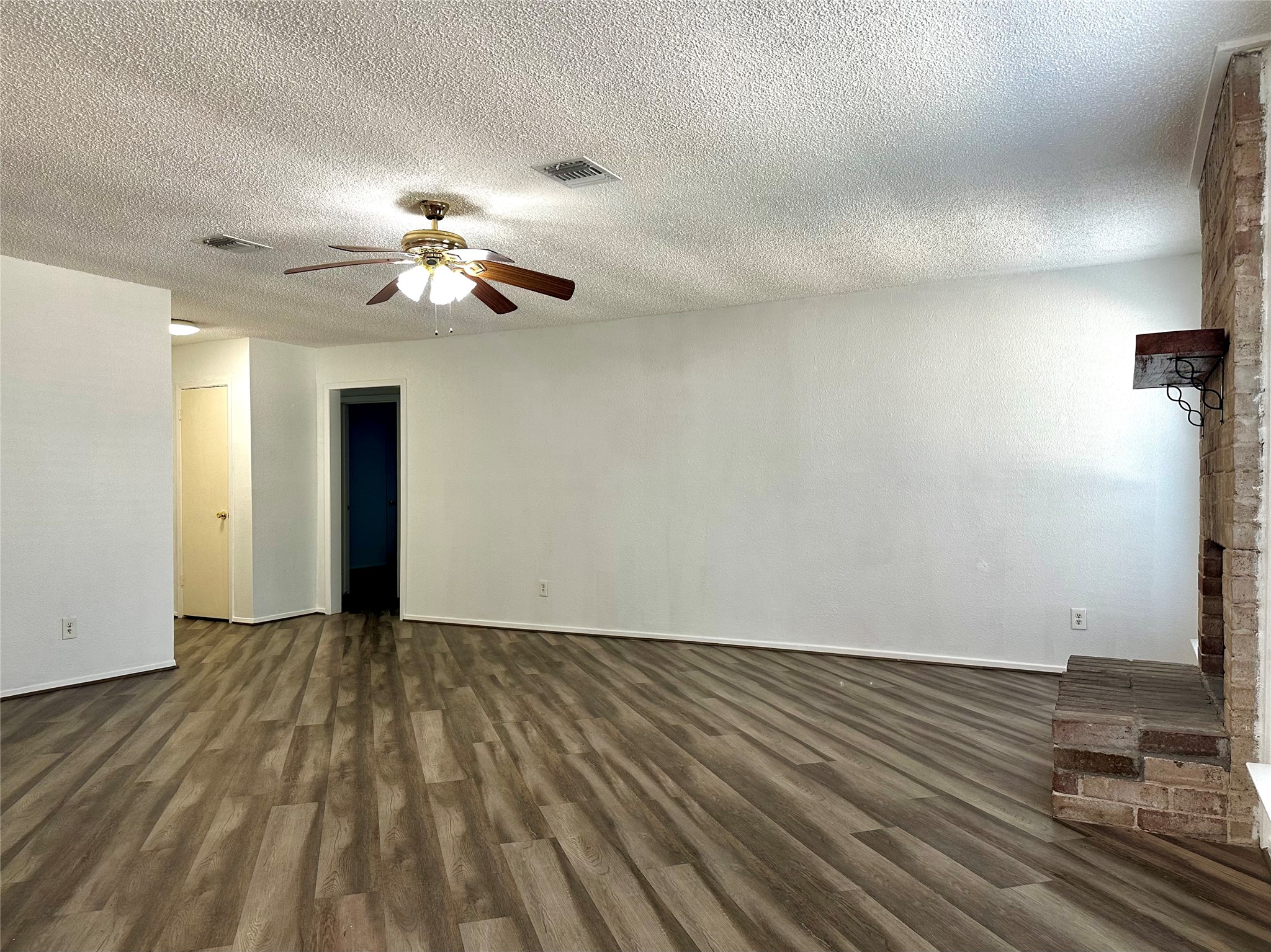 4927 Adonis Drive Spring, TX 77373 - Photo 4 of 11 a view of an empty room with chandelier fan and wooden floor