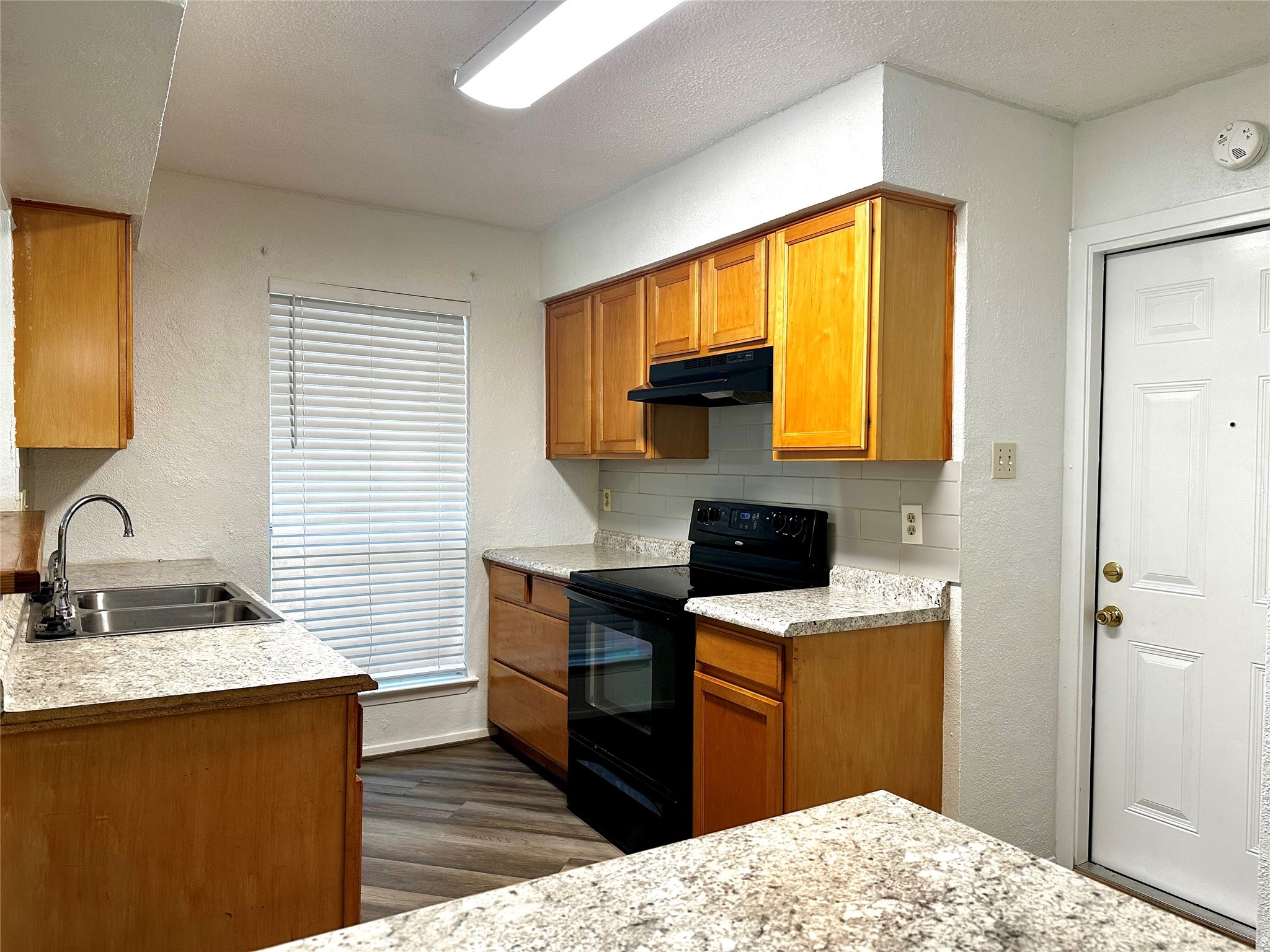 4927 Adonis Drive Spring, TX 77373 - Photo 7 of 11 a kitchen with a sink appliances cabinets and a window