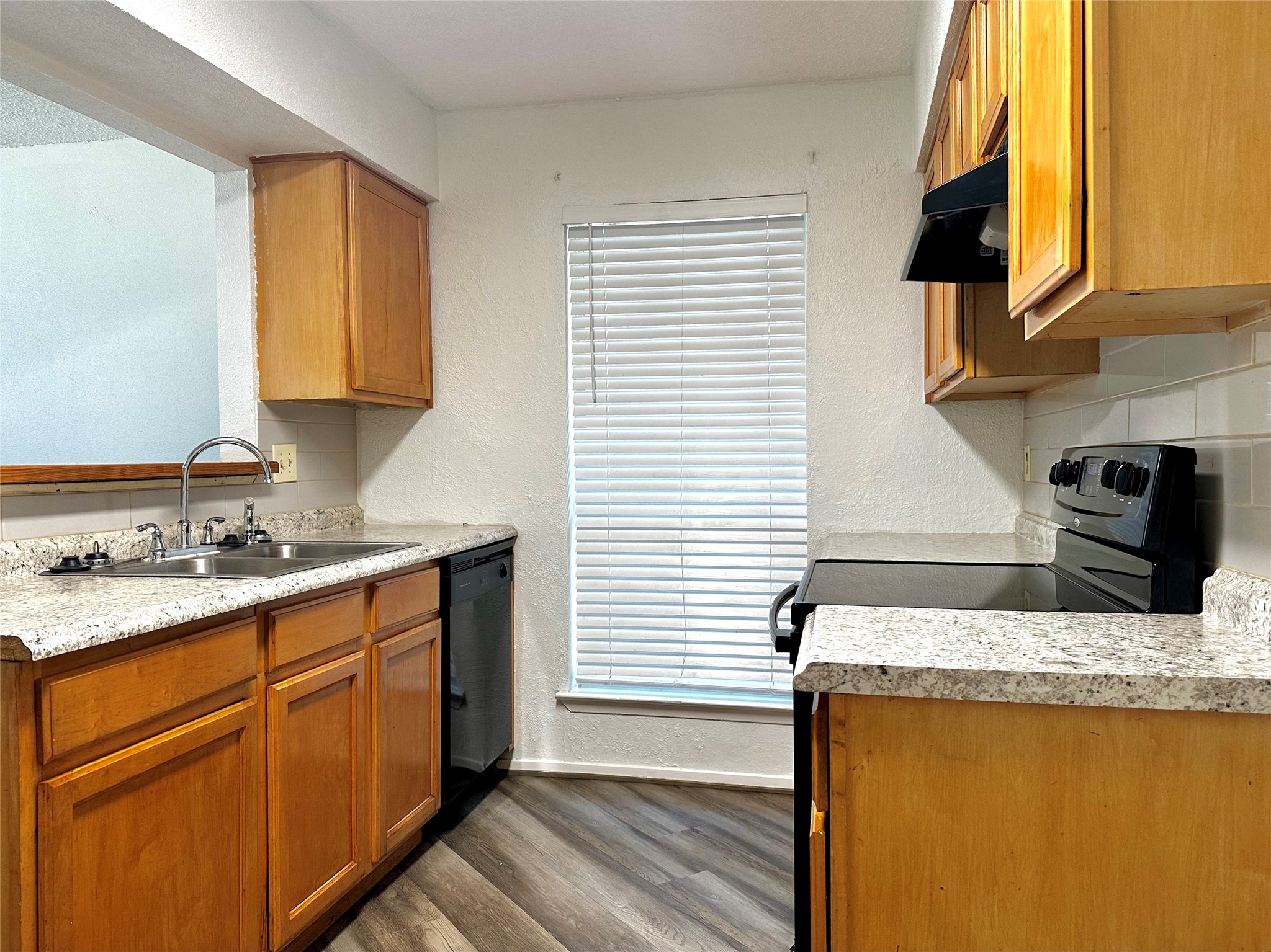 4927 Adonis Drive Spring, TX 77373 - Photo 8 of 11 a kitchen with stainless steel appliances granite countertop a sink stove and refrigerator