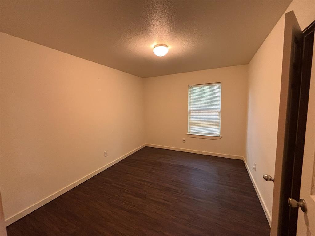 4744 Stokes Street Dallas, TX 75216 - Photo 9 of 20 an empty room with wooden floor and windows