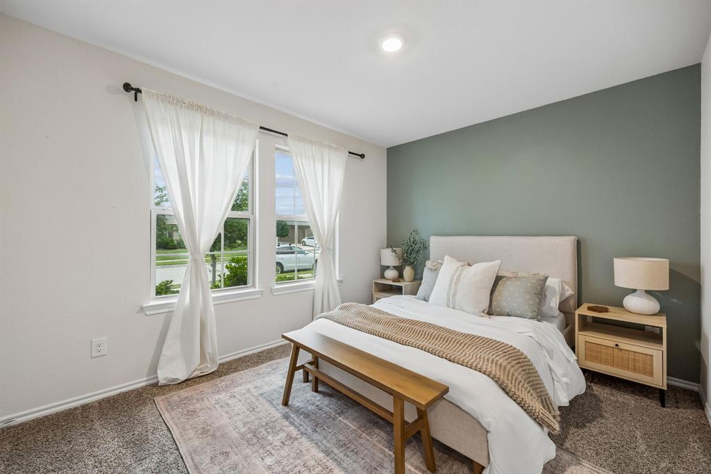 1107 Ringgold Road Forney, TX 75126 - Photo 20 of 27 Secondary bedroom #1 featuring a distinctive accent wall, two large windows with white trim, and a recessed ceiling light