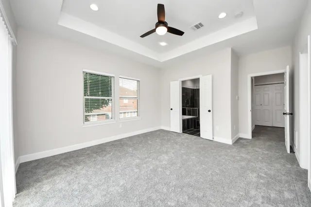 an empty room with a ceiling fan and a ceiling fan