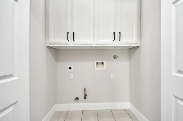 an empty room with ceiling fan and window